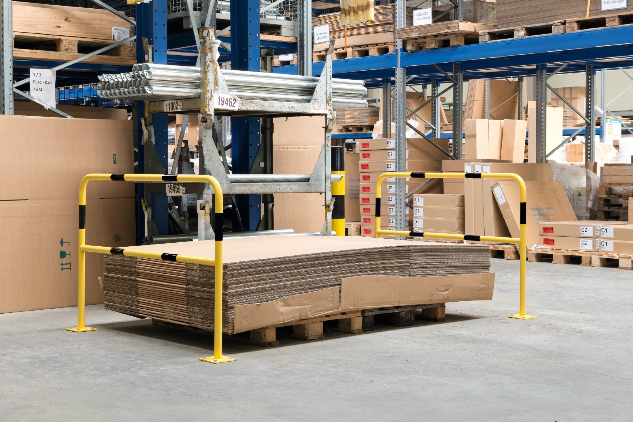 Hoop guards installed in warehouse protecting pallets