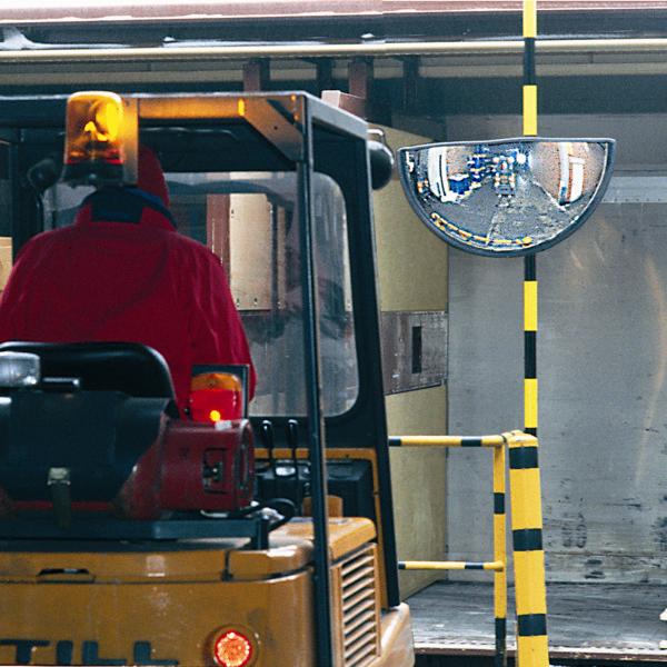 Convex mirror showing industrial vehicles